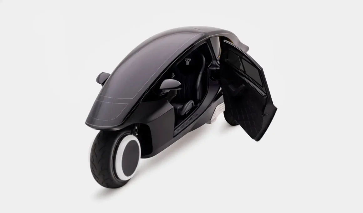 High-angle front view of the Trinity EV with its single gull-wing door open, showing the solo seat and quilted interior.