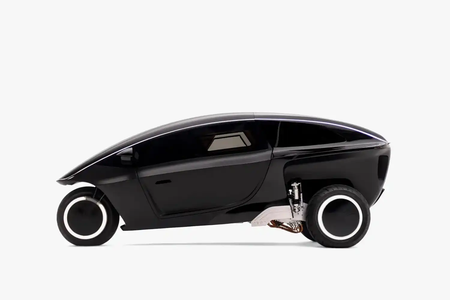 Side profile of the Trinity three-wheeler in matte black against a white background, showing the suspension and LED wheels.