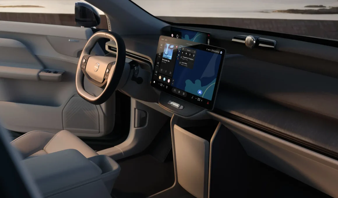 Interior of the Volvo EX60 with a large central touchscreen and minimalist steering wheel.