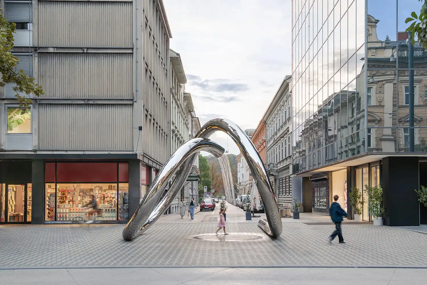 Perspective view of the steel water loop between modern and historic buildings in Ljubljana.