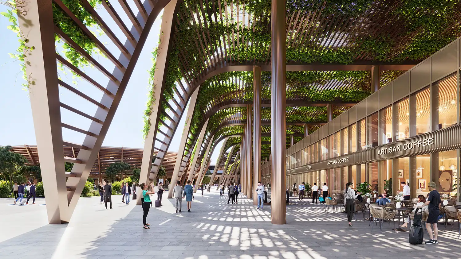 An outdoor shaded walkway at the airport with tall bronze columns, a green-draped trellis roof, and "Artisan Coffee" shops with outdoor seating.