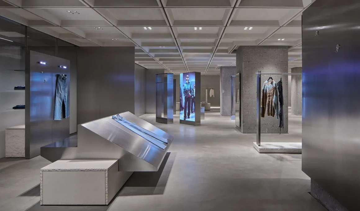Industrial-chic interior of Zara Nanjing flagship by AIM Architecture featuring stainless steel displays, concrete textures, and modular lighting.