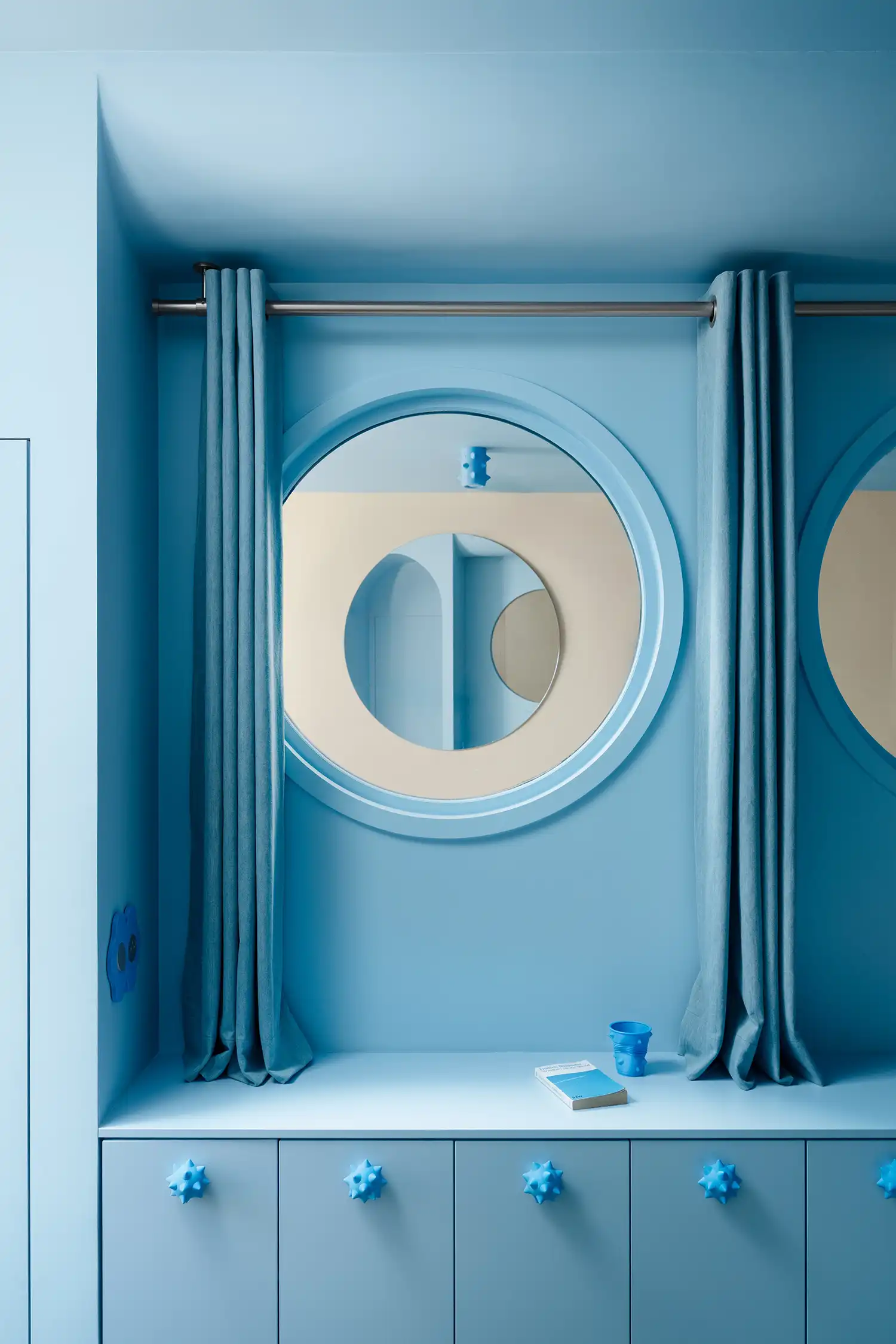 Circular mirrors act as "virtual portholes," reflecting the space to amplify the perception of the small interior.