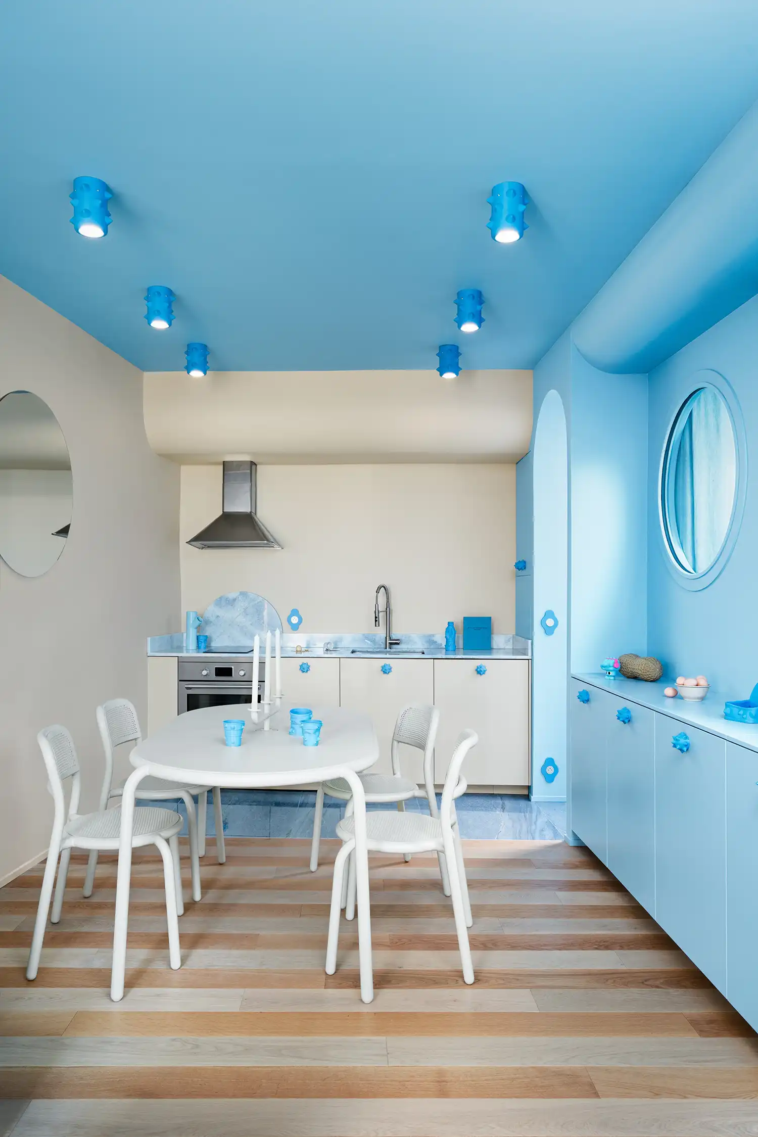 The kitchen and dining area showcase the "marinière" floor and bespoke sea-creature hardware.