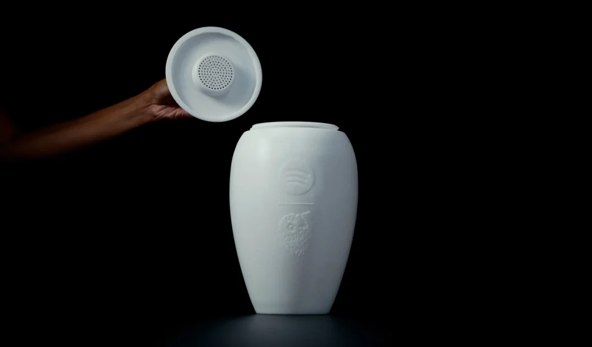 Close-up of the Eternal Playlist Urn with the lid removed to reveal the integrated Bluetooth speaker grille.