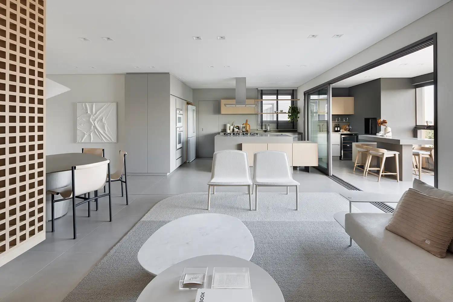 Seamless transition from the minimalist kitchen and dining room to the integrated balcony.
