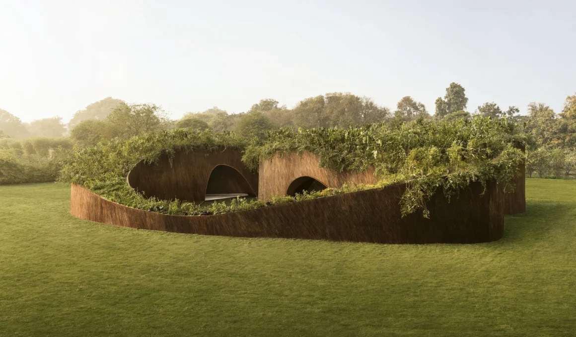 Wide view of the Aranyani Pavilion by T__M.Space with curved walls and lush rooftop greenery.