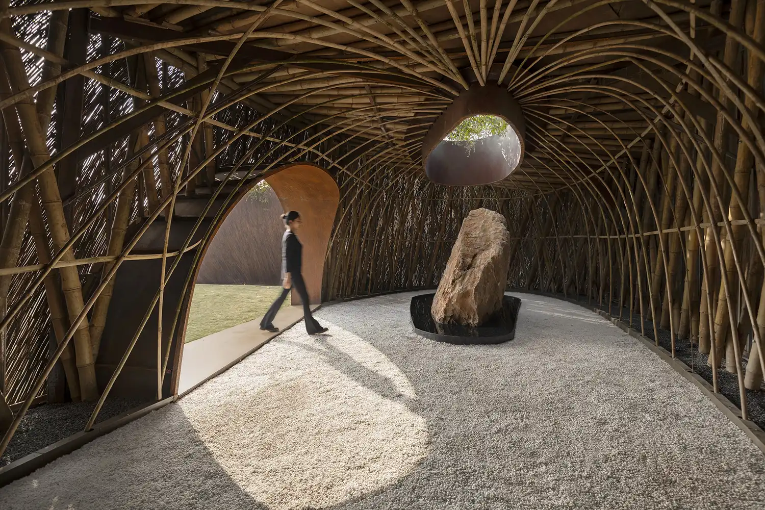 Interior view of Aranyani Pavilion showing bamboo radial structure and a central monolith.