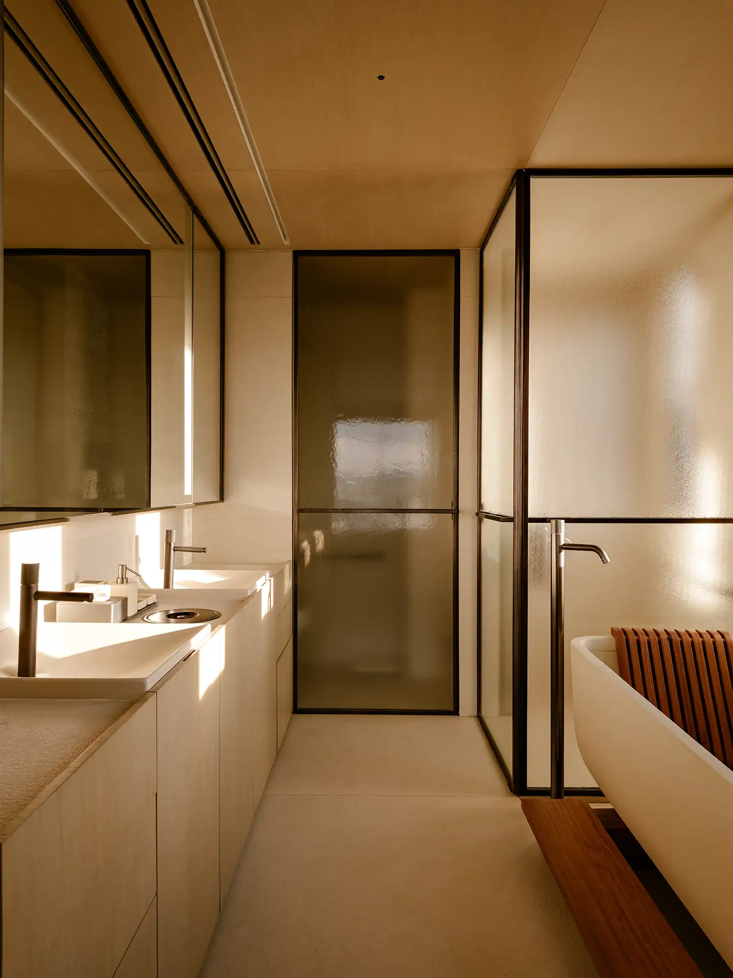 Minimalist master bathroom with dual sinks and freestanding bathtub