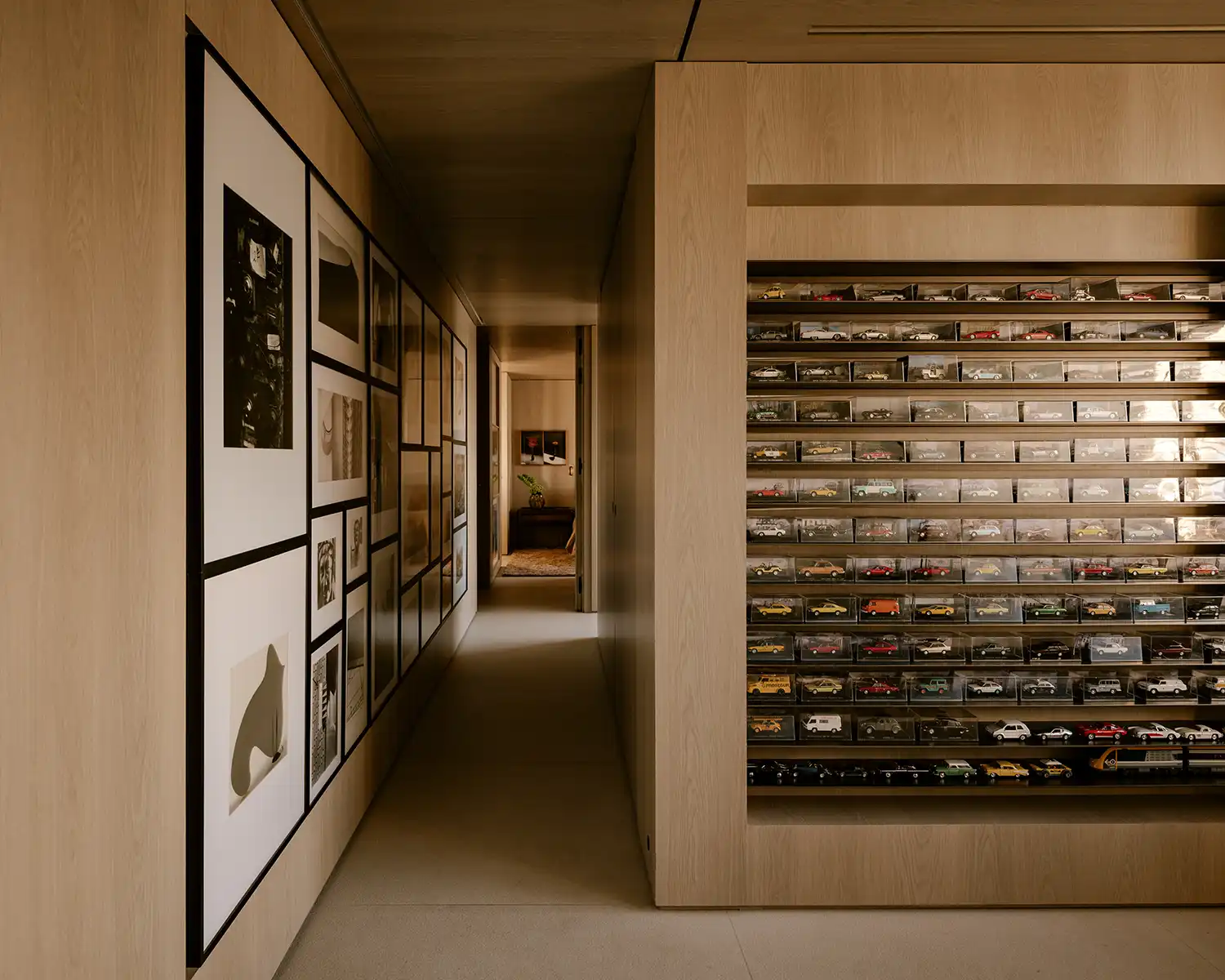 Hallway with photography collection and miniature car display niches