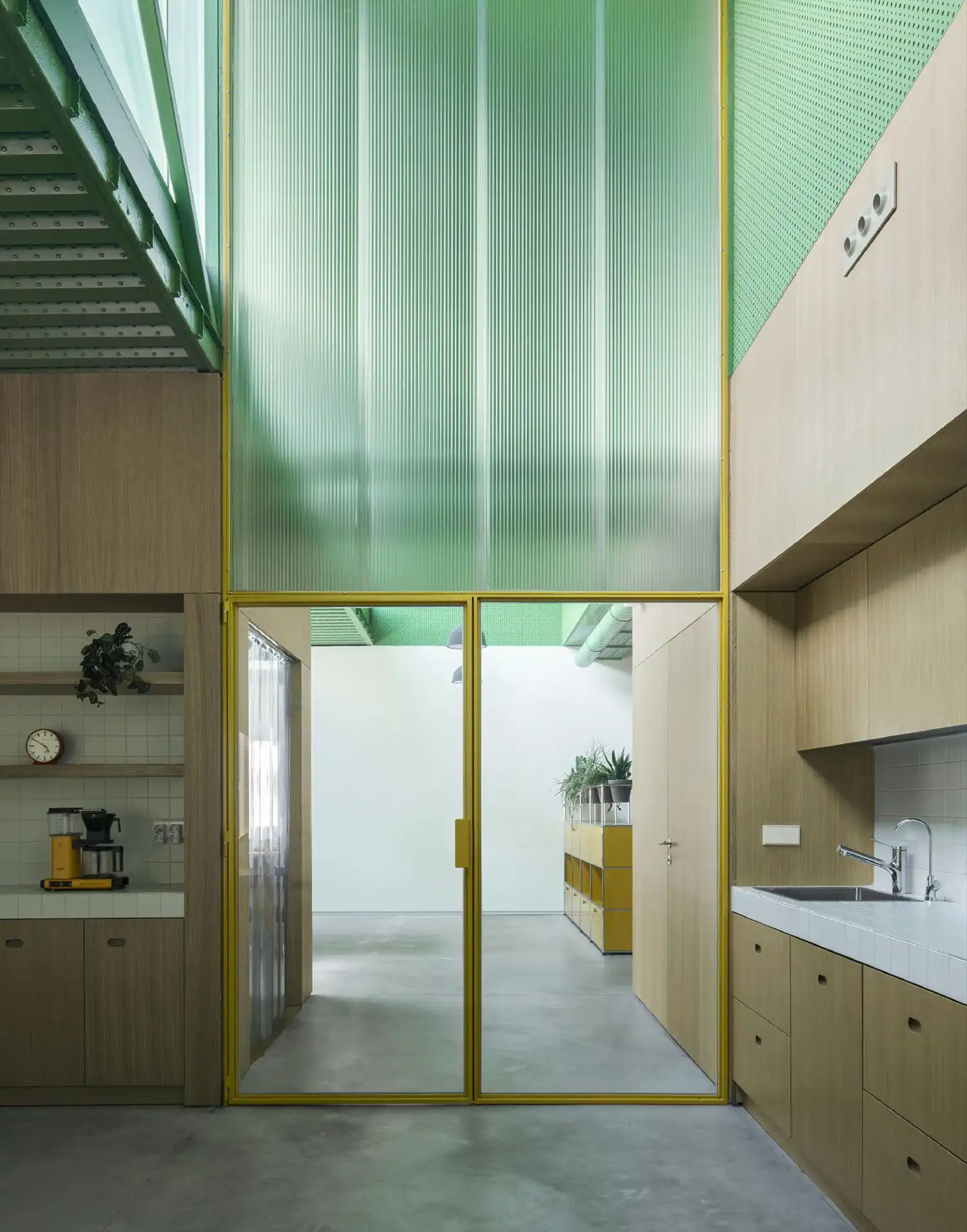 Modern office kitchen and meeting area with yellow frames and polycarbonate panels