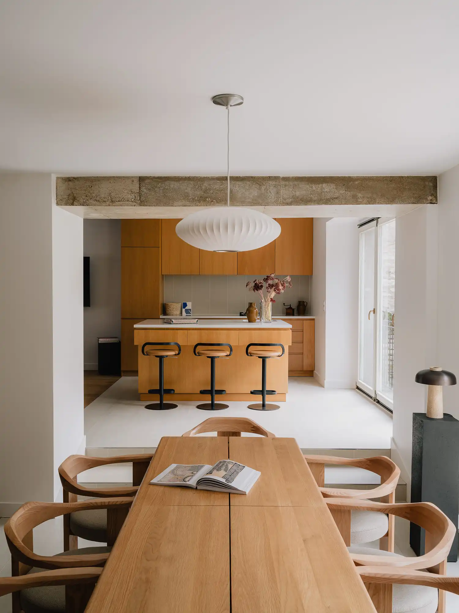 Open-plan kitchen and dining room with a central oak island and Nelson Bubble Lamp.