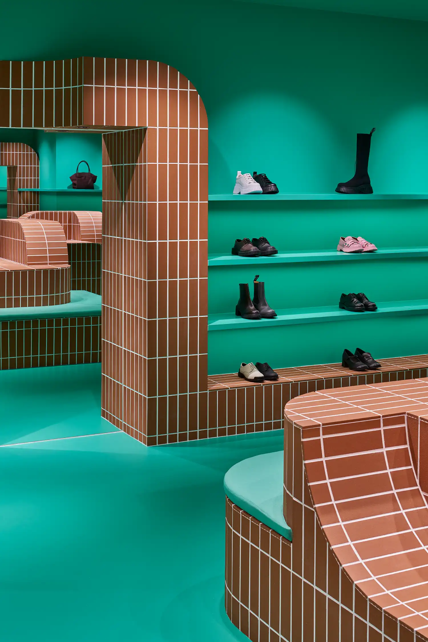 Detail of a terracotta tile archway reflecting in a mirror within the teal store.