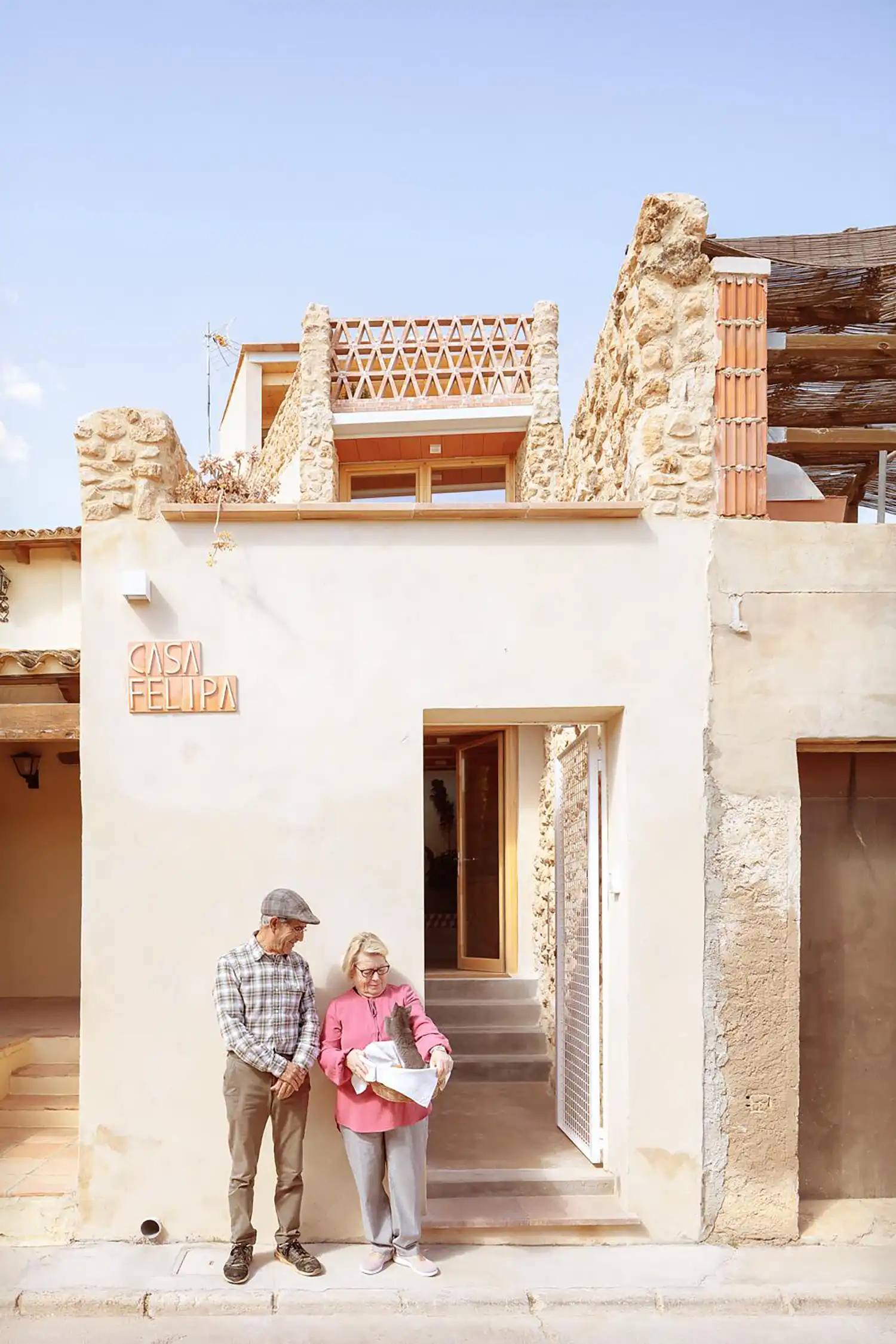 Exterior facade of Casa Felipa with an elderly couple standing by the entrance.