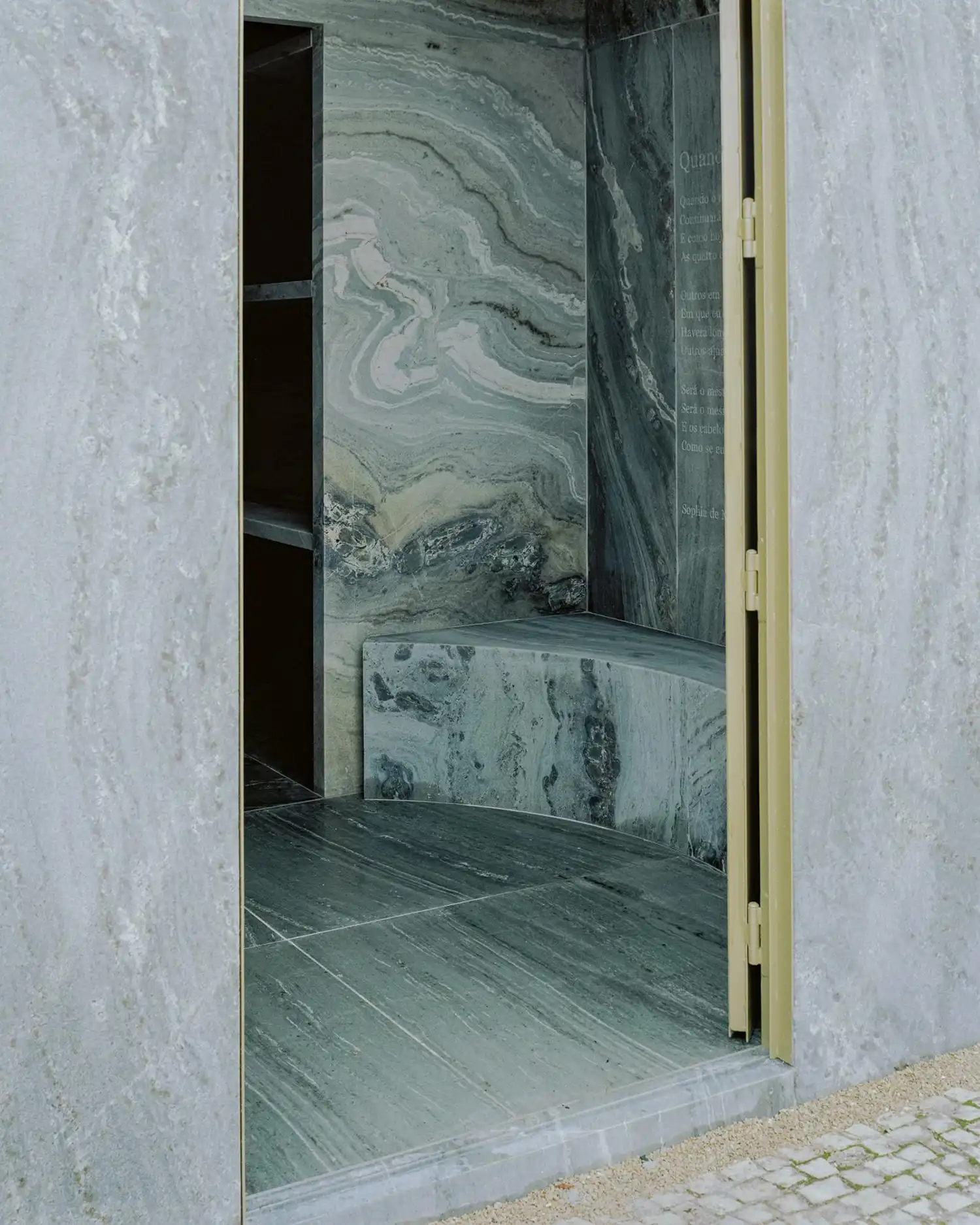 Detail of a marble bench and inscribed poetry inside the family tomb.