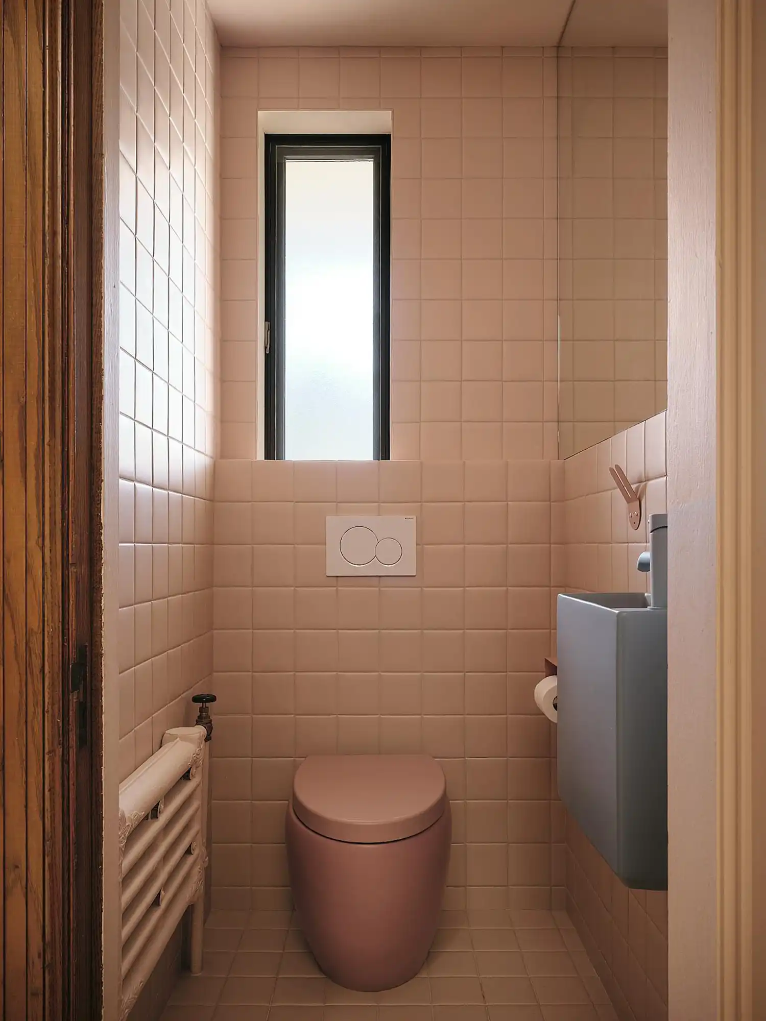 A theatrical, monochromatic moment in shades of pink, inspired by the cinematic universe of Wes Anderson.