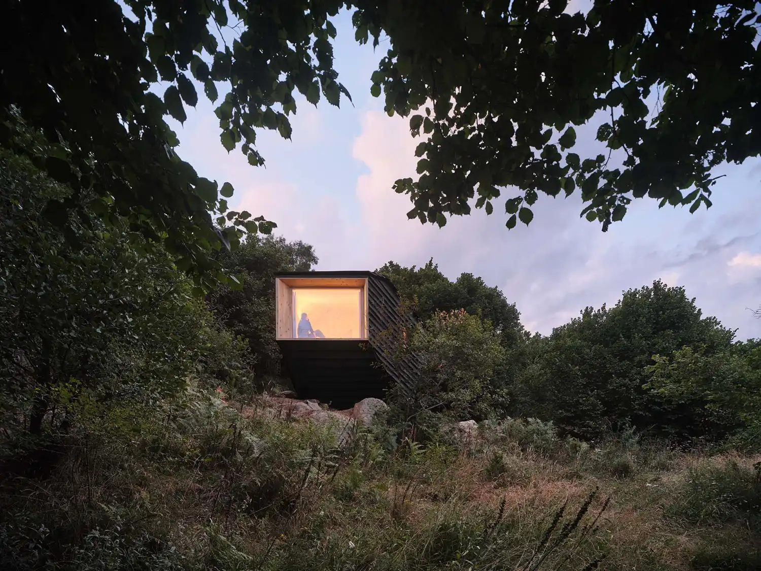 Forestone cabin dusk illumination mountain landscape