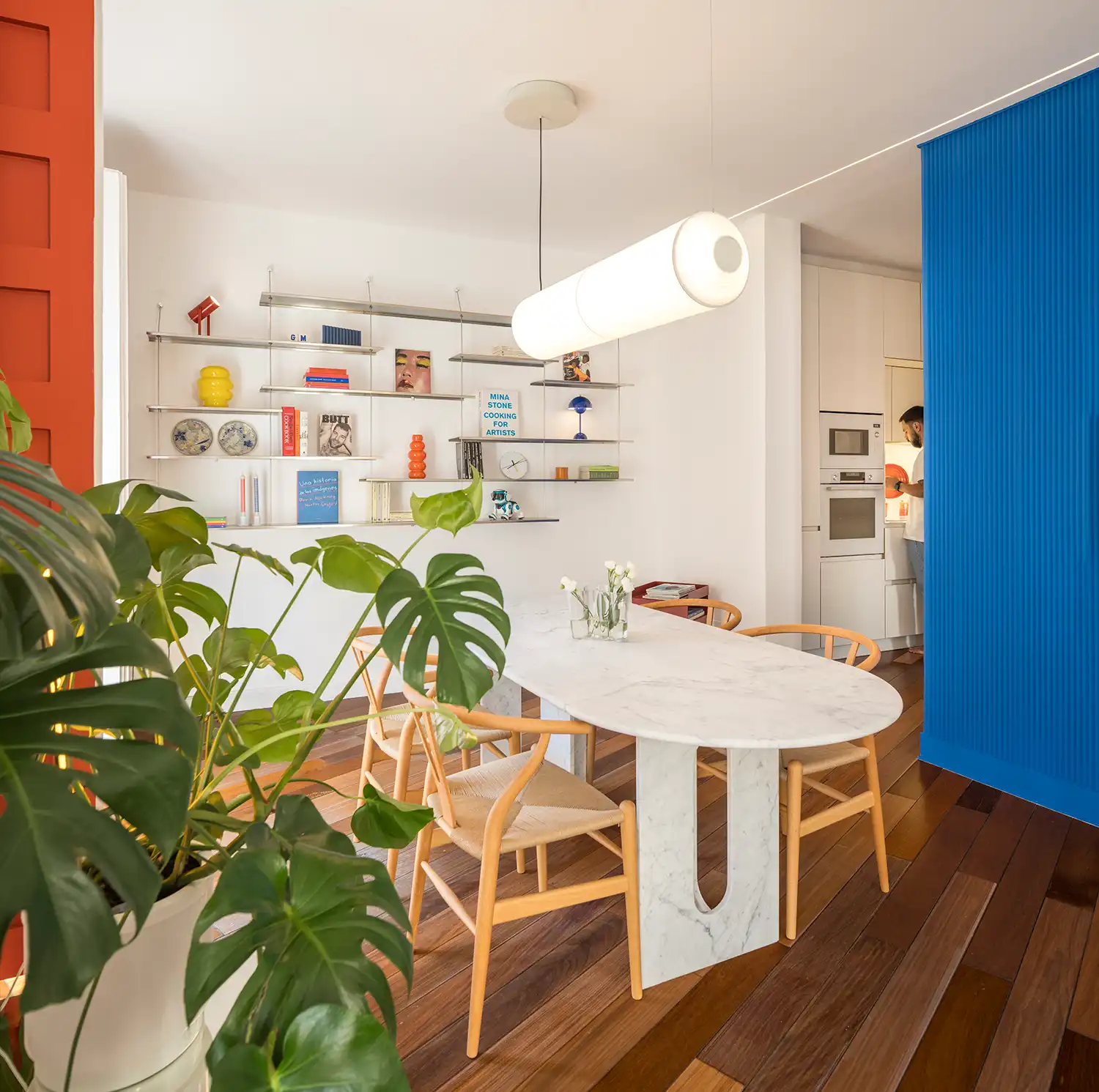 Transition from dining area to kitchen with electric blue textured wall