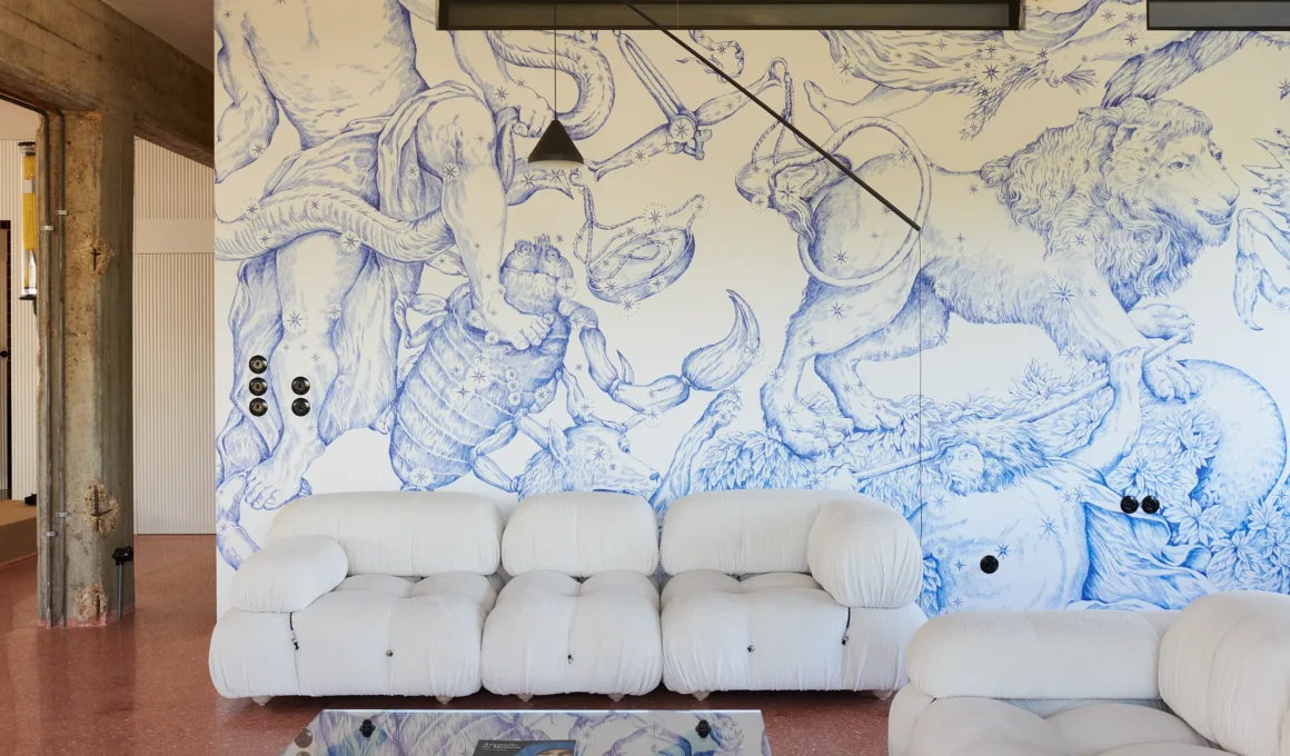Site-specific blue mural by Pietro Ruffo behind a white Bellini Camaleonda sofa in a Rome apartment.