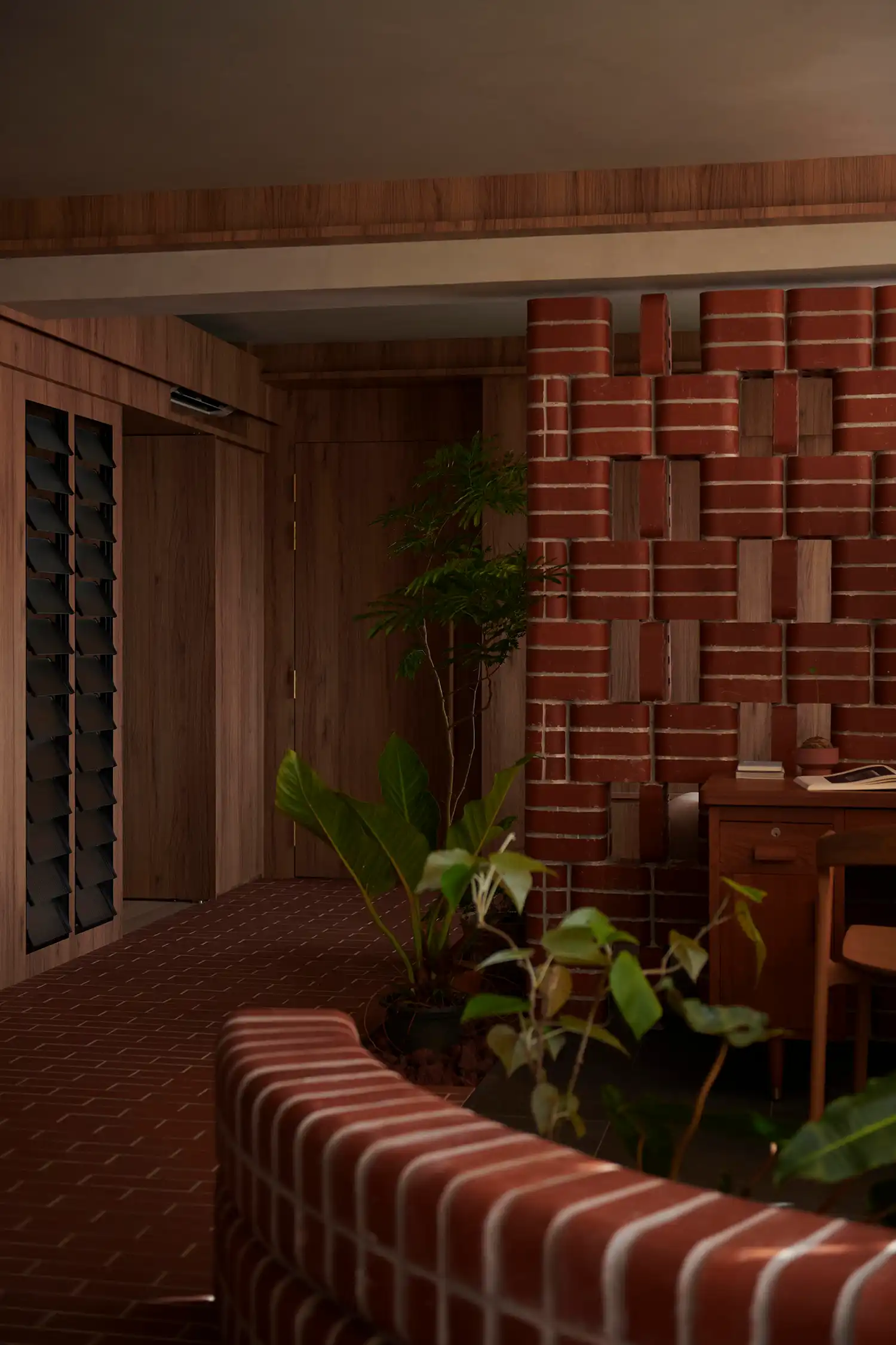 Detail of curved brick masonry and indoor greenery in L Architects' Singapore project.