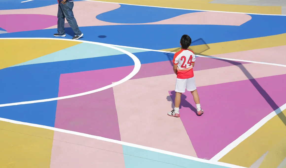 Vibrant hand-painted geometric patterns on a sports court in Veracruz