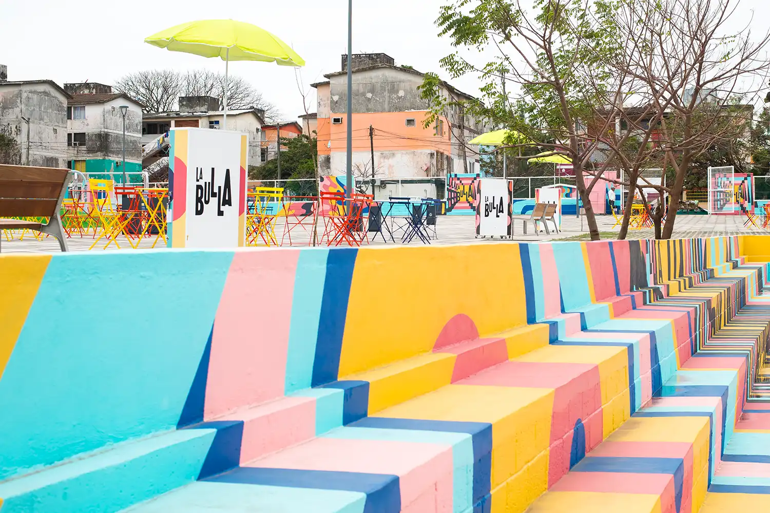 Outdoor seating area with colorful furniture and "La Bulla" branded modules.