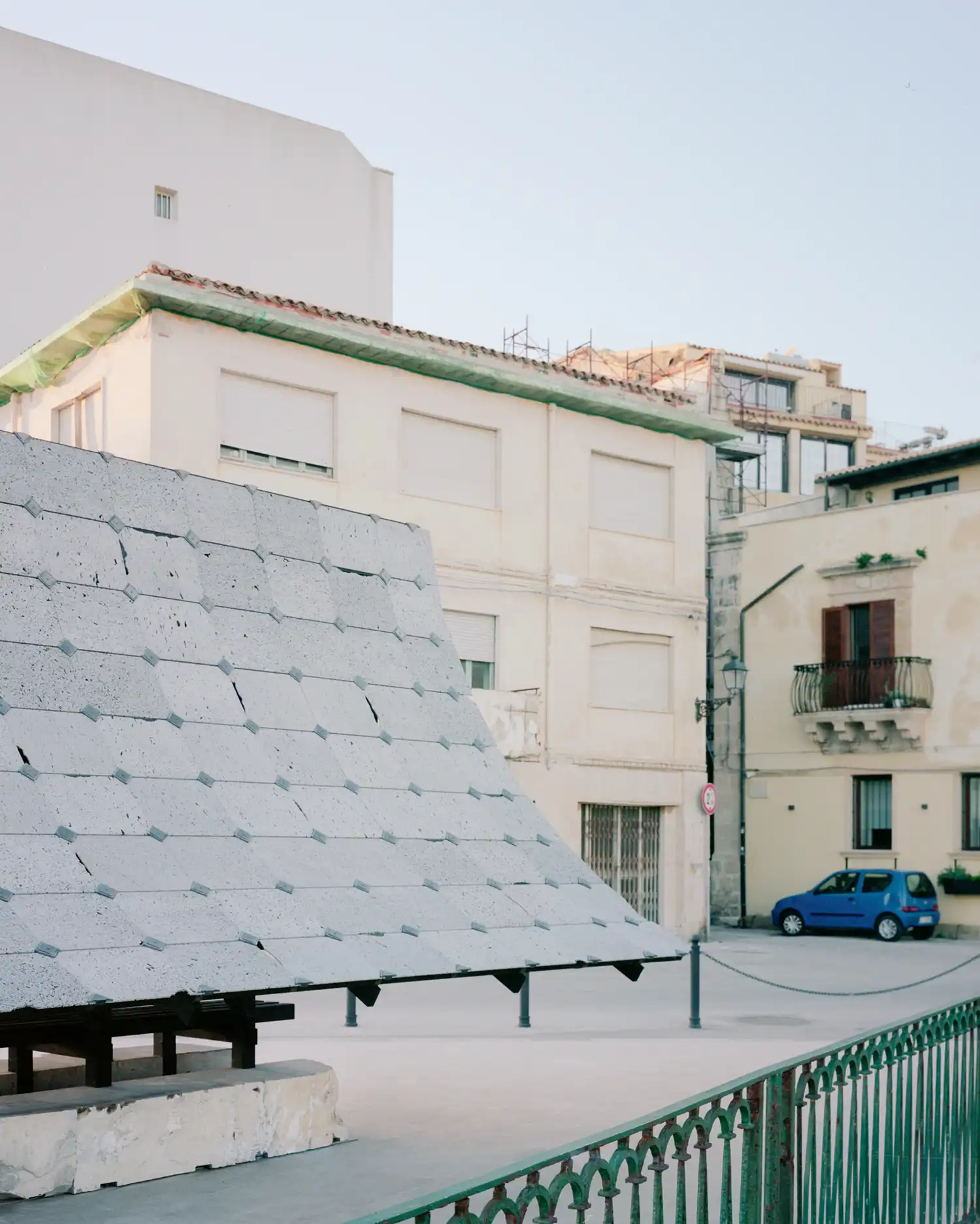 Asympta installation contrasted against the traditional urban fabric of Ortigia