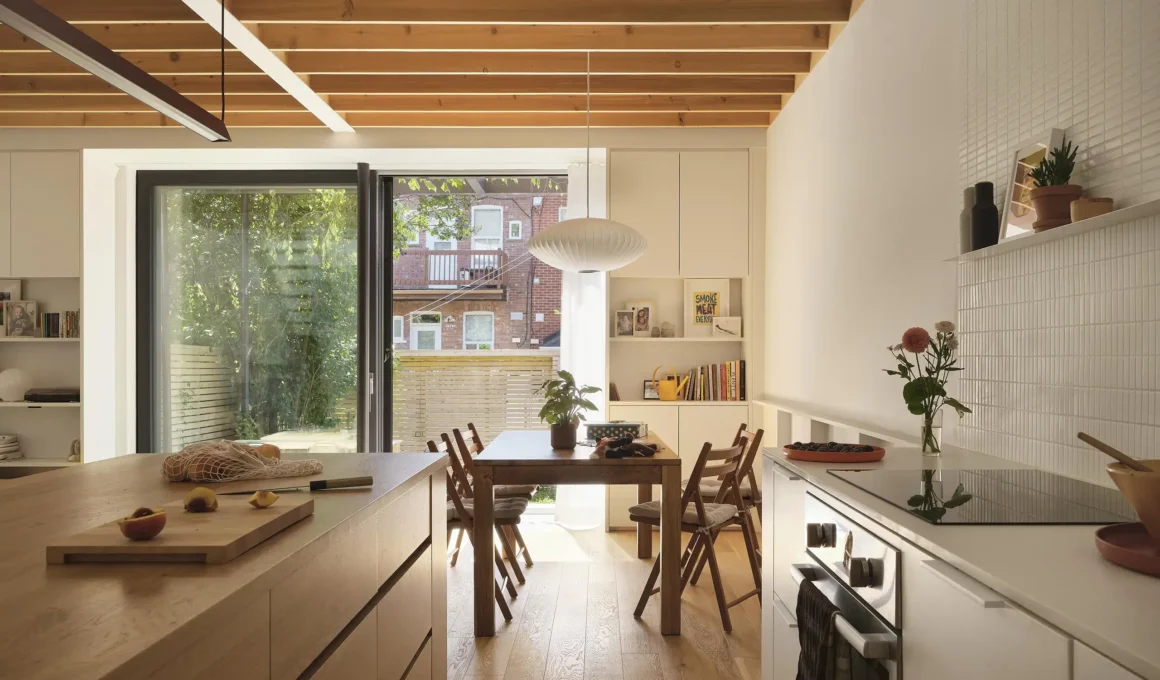 Kitchen and dining area with exposed cedar joists and white oak flooring in a Montreal duplex.