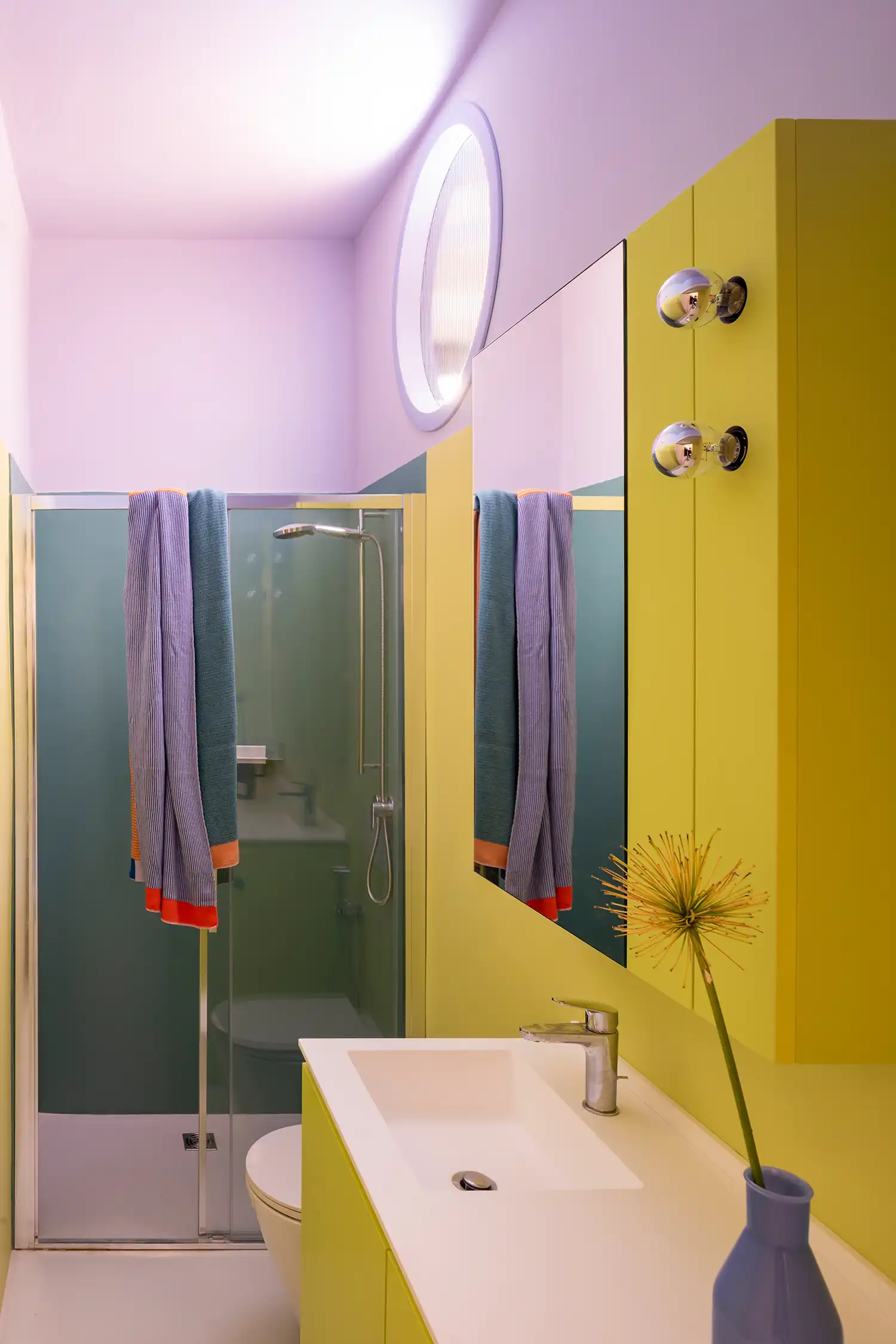 Vibrant bathroom interior with lilac walls and acid green cabinets