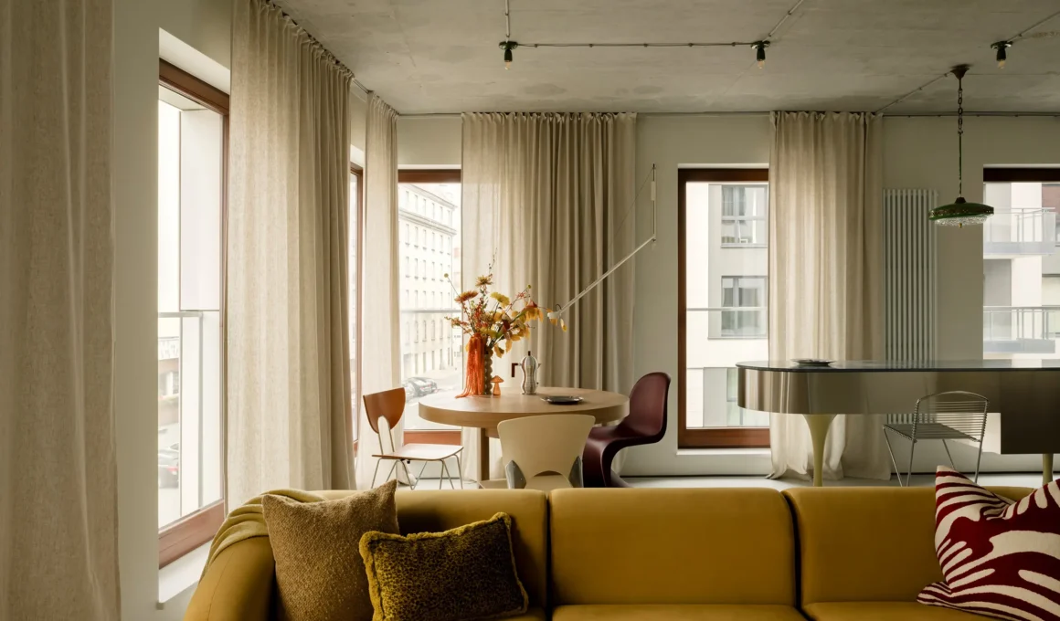 Open-plan Warsaw living room with raw concrete ceiling and yellow sofa