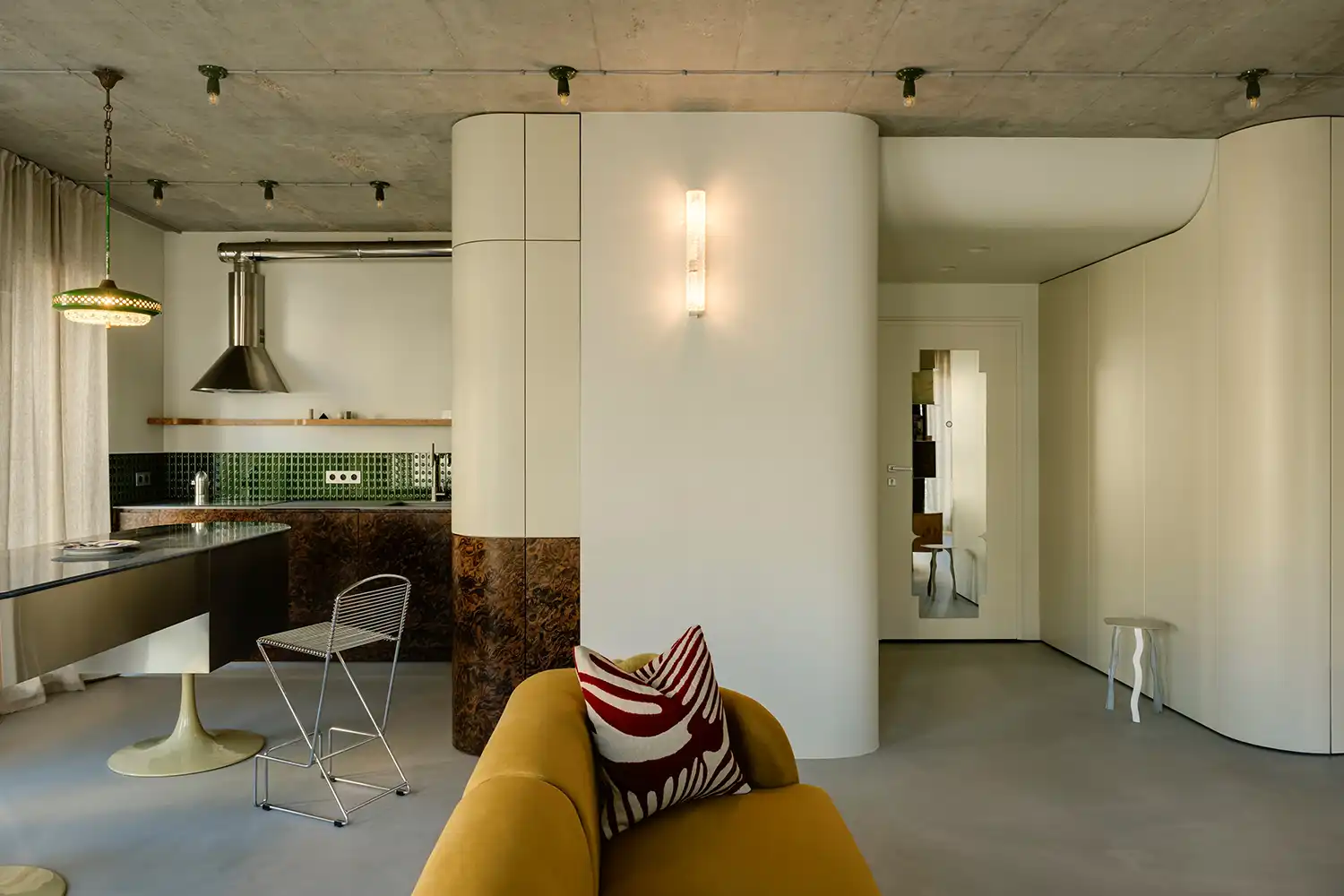 Curved white walls and burl wood accents in Warsaw apartment