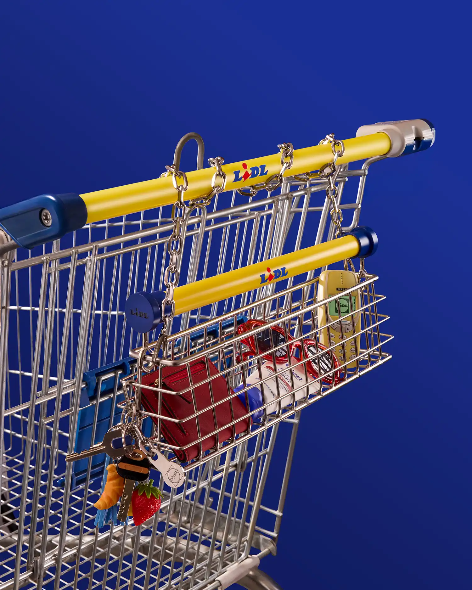 Close-up of the small Trolley Bag accessory hanging from a full-sized Lidl supermarket trolley.