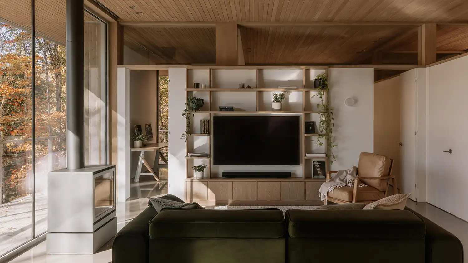 Open-plan living area at Perchée featuring a built-in library and a white modern fireplace.