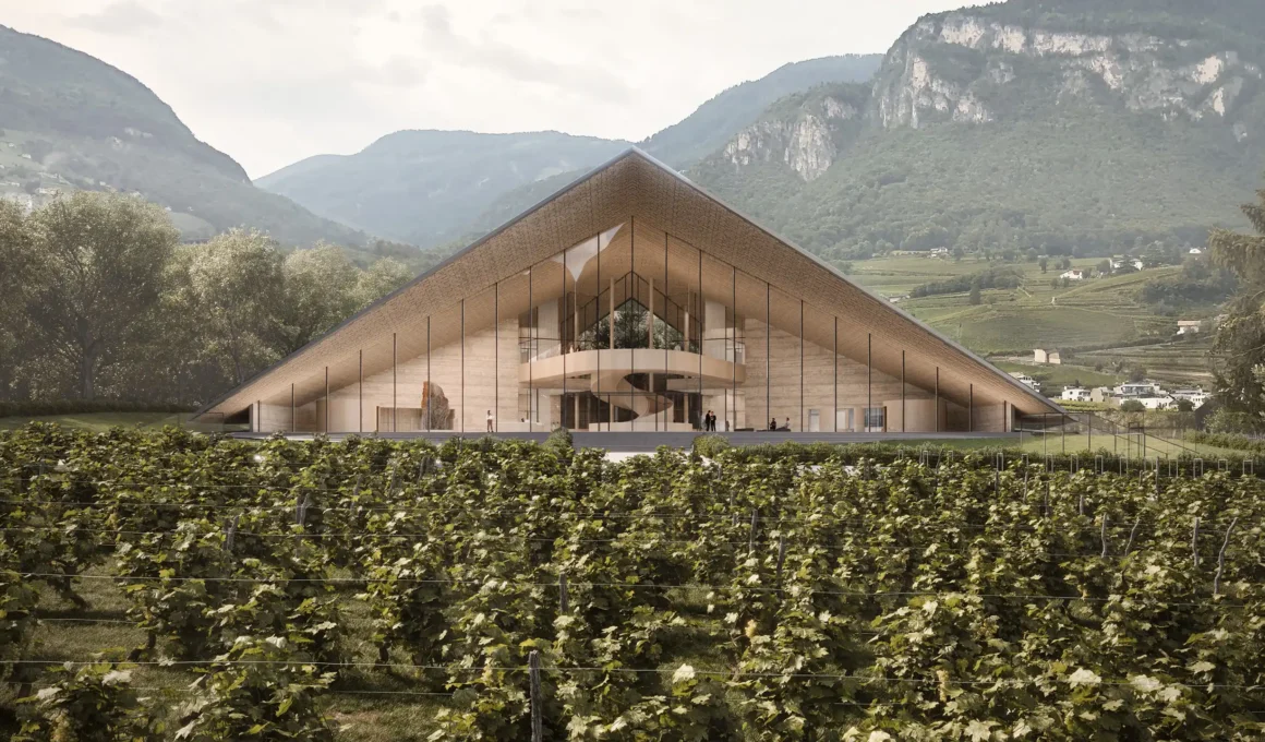 Symmetrical front view of the Kulturgüterdepot with a gabled roof and vineyard in the foreground.