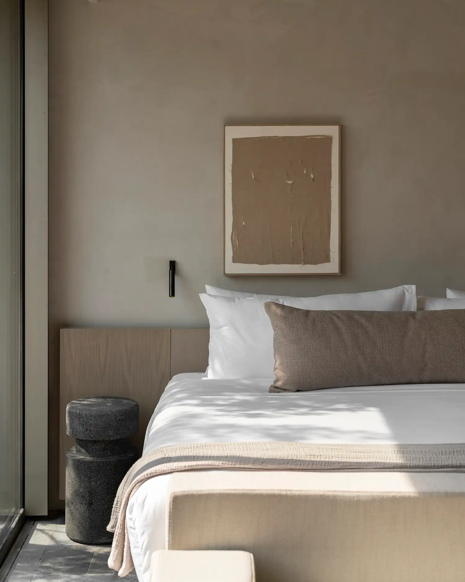 Minimalist bedroom textiles and stone nightstand LAMARTINE