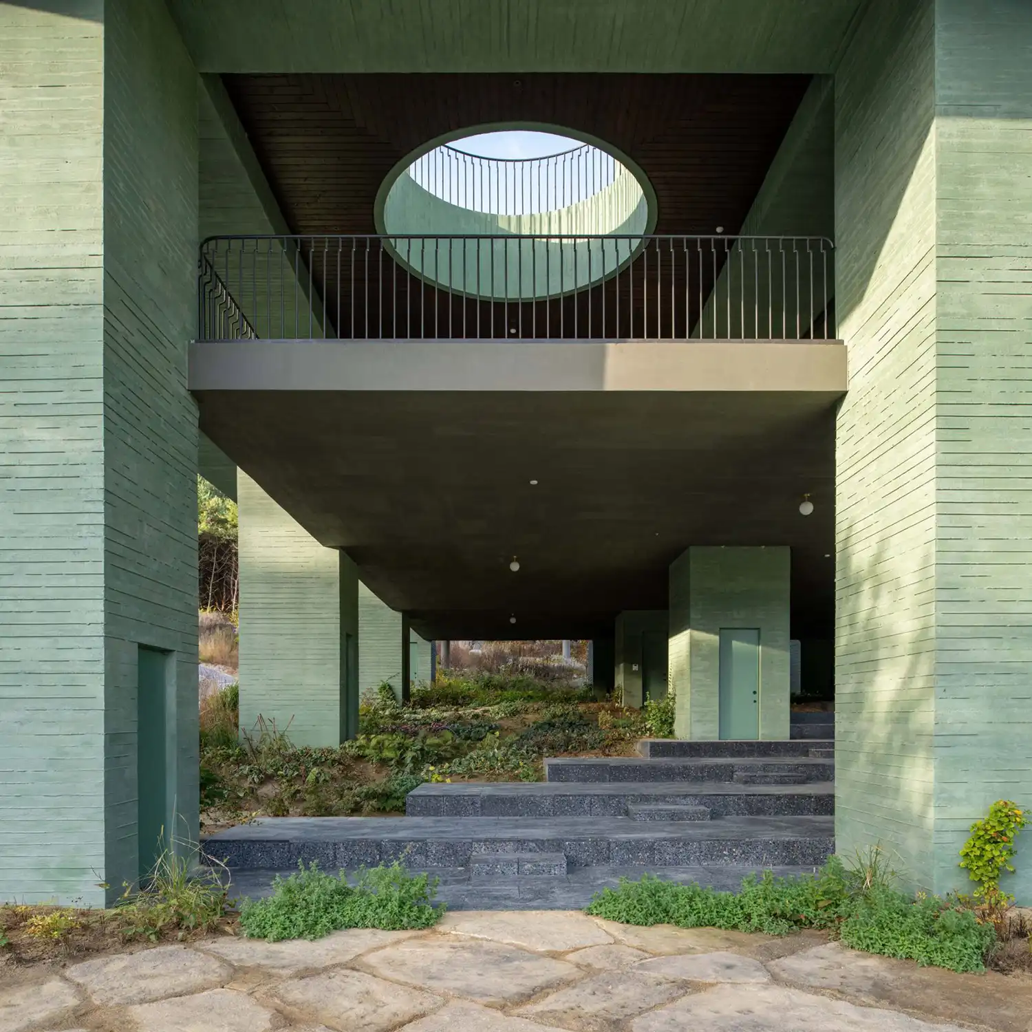 Ground level amphitheater of REST showing circular skylight and stone steps