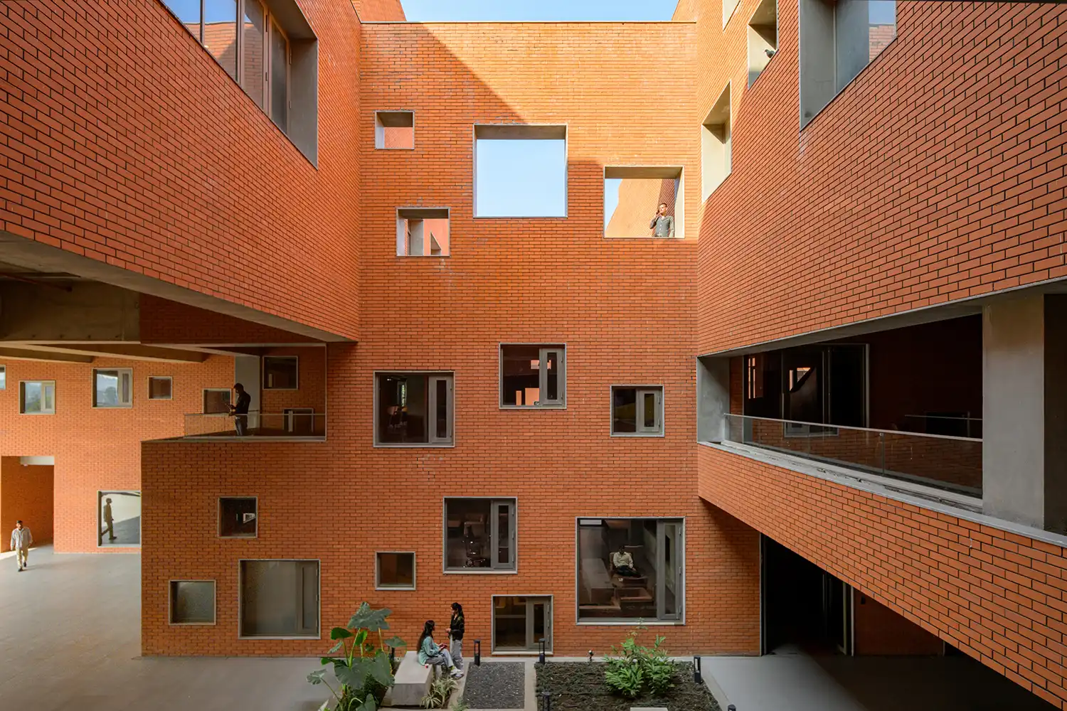 Internal courtyard with brick walls and irregularly placed windows.