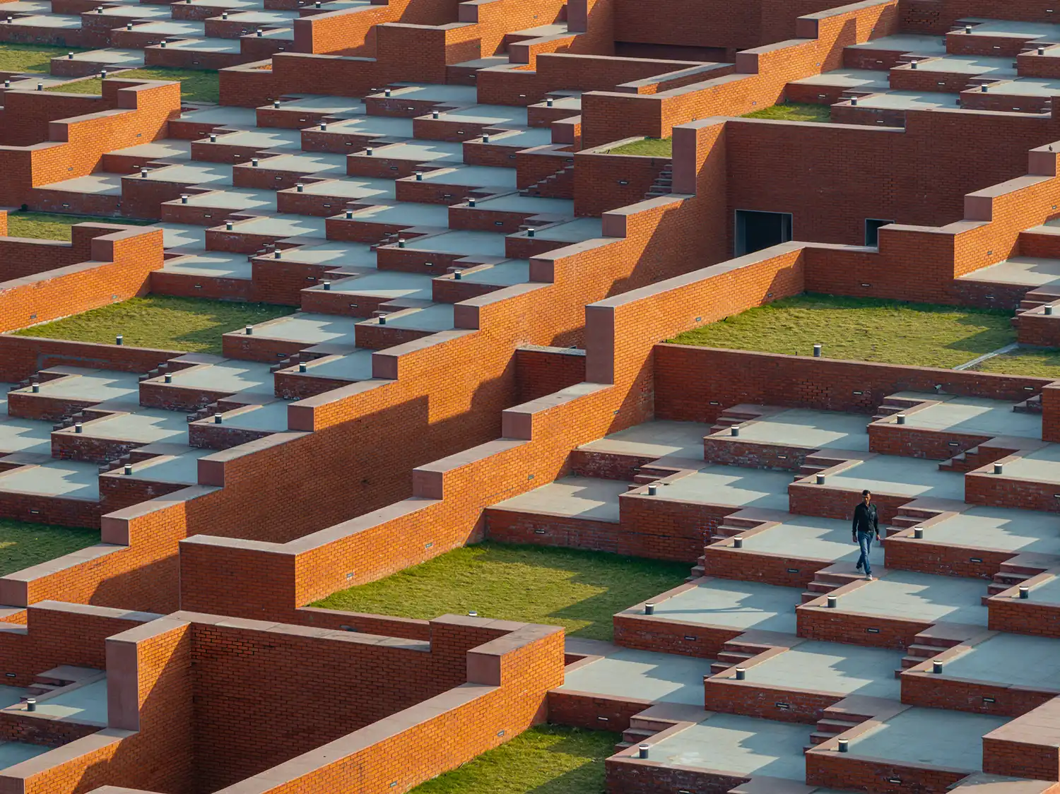 Close-up of a student walking on the stepped rooftop garden.