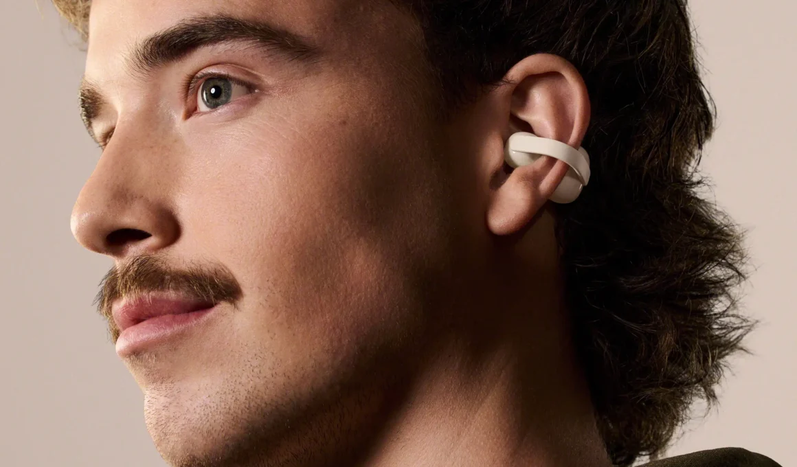 Profile view of a user wearing the off-white Sony LinkBuds Clip.