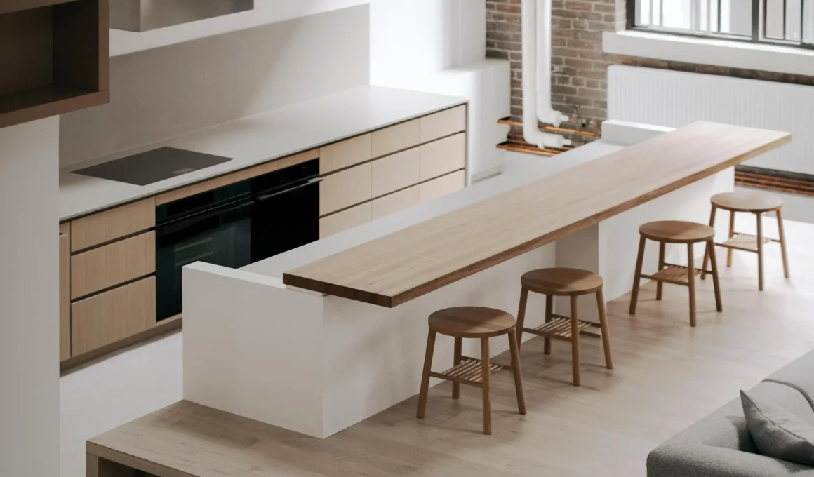 Minimalist kitchen island and white oak platform in Toronto loft