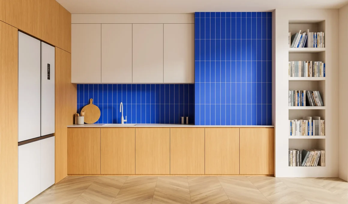 A modern minimal kitchen featuring light wood cabinetry and a vibrant blue vertical stack tile backsplash, demonstrating removable solutions for personalizing rental spaces.