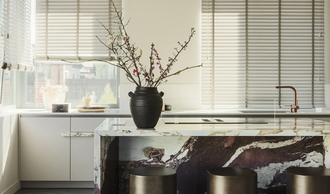 Calacatta Viola marble kitchen island with deep burgundy veining in a Kyiv home.