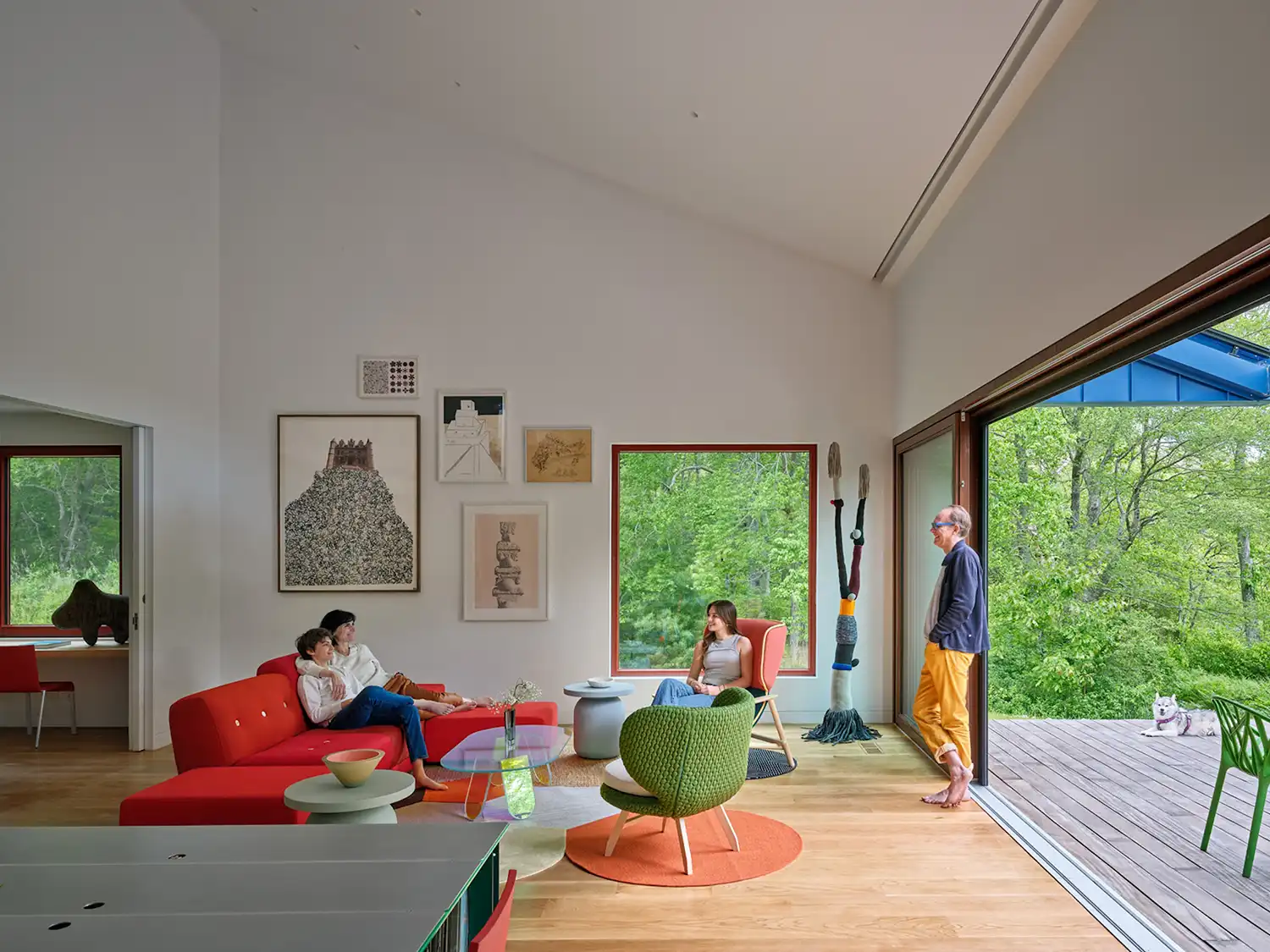 Family relaxing in the modern, bright living room of the Riverhouse.