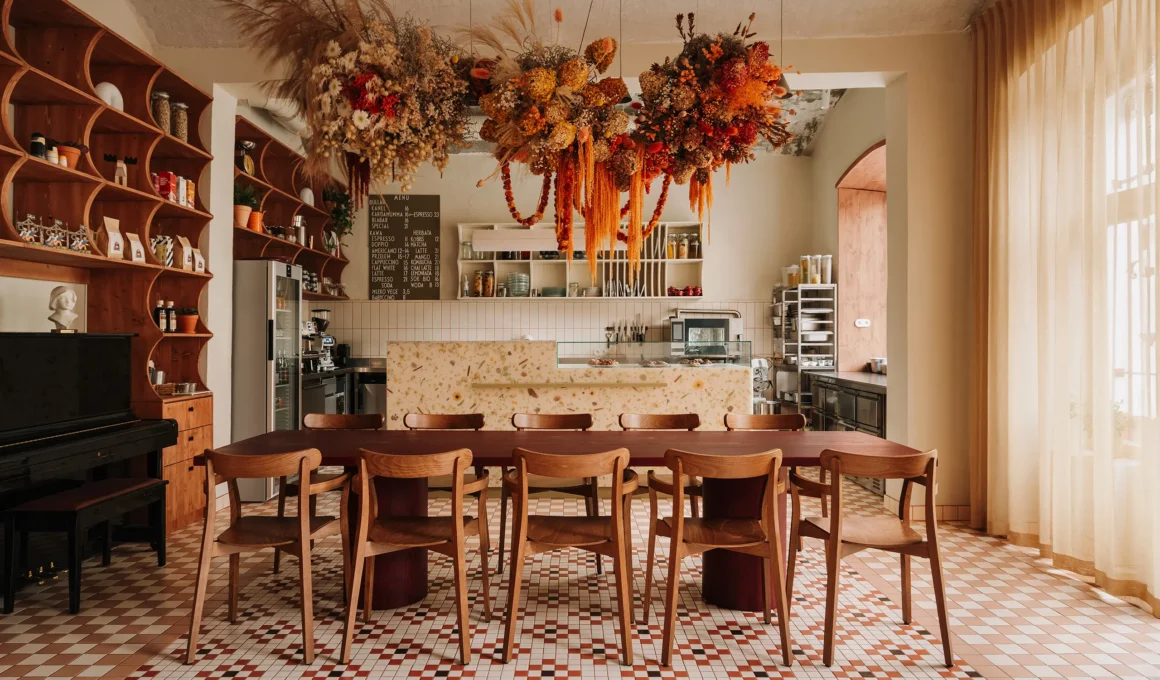 Dala restaurant communal dining area with hanging floral installation and checkered floor
