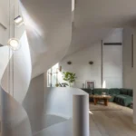 Sculptural white helix staircase in a modern London living room by Archi-Tectonics.