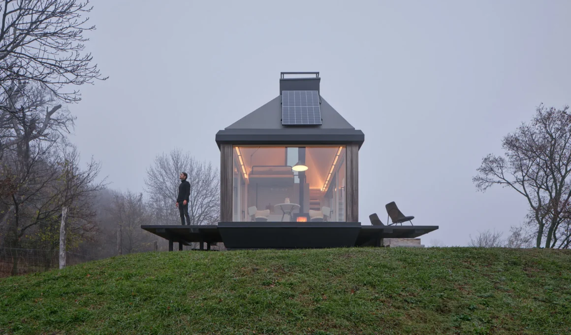 Exterior view of Cabin Devín by Ark-Shelter on a misty hill in Slovakia.
