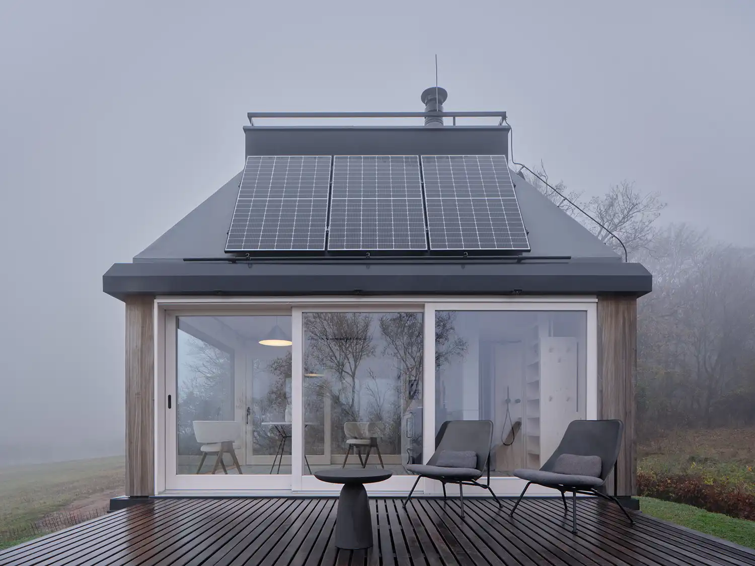 Fold-down terrace and glass façade of the Ark-Shelter cabin.