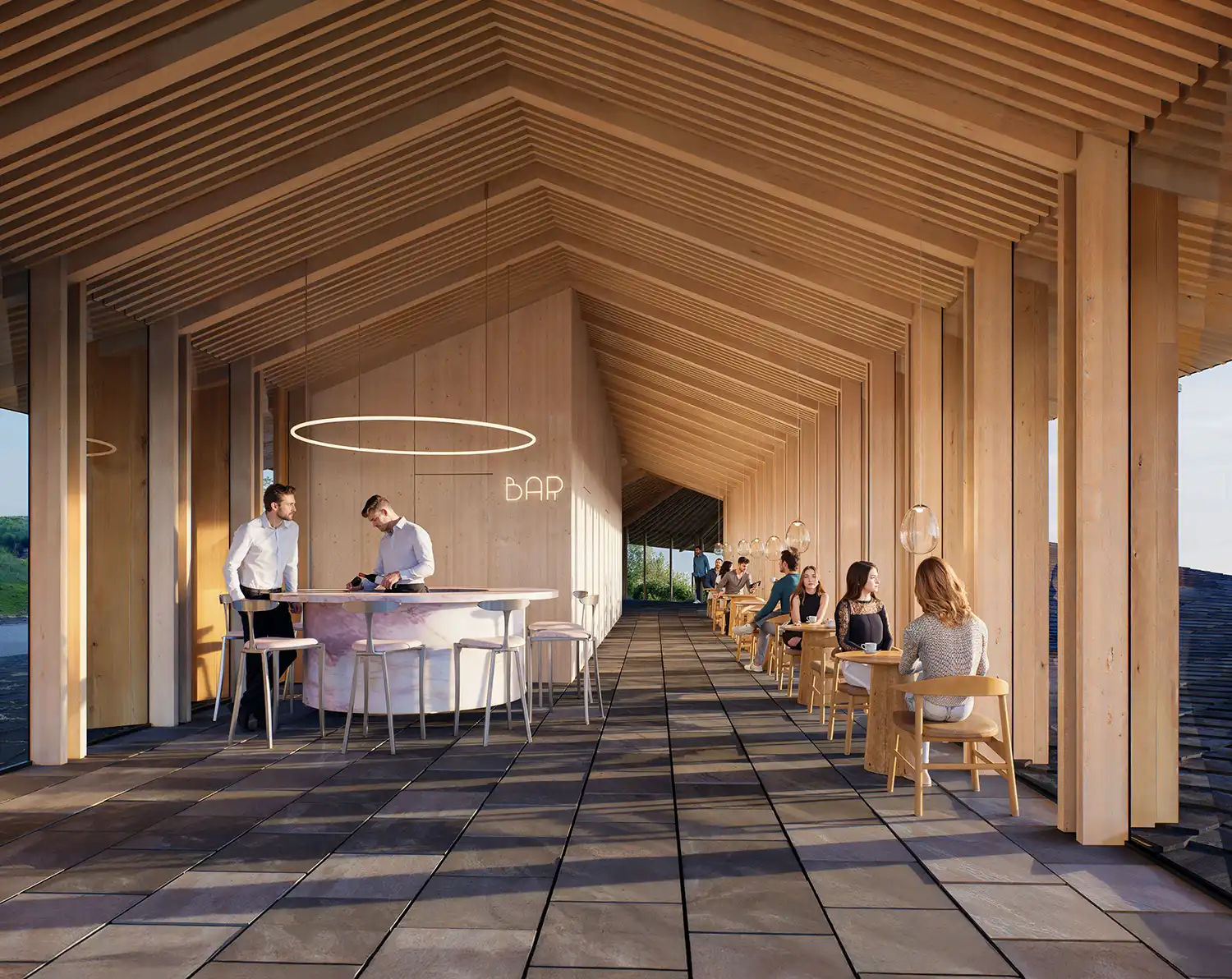 An interior shot of a modern restaurant/bar with high ceilings and warm wood paneling. The bar is a pink circular island, with patrons seated at tables to the right.