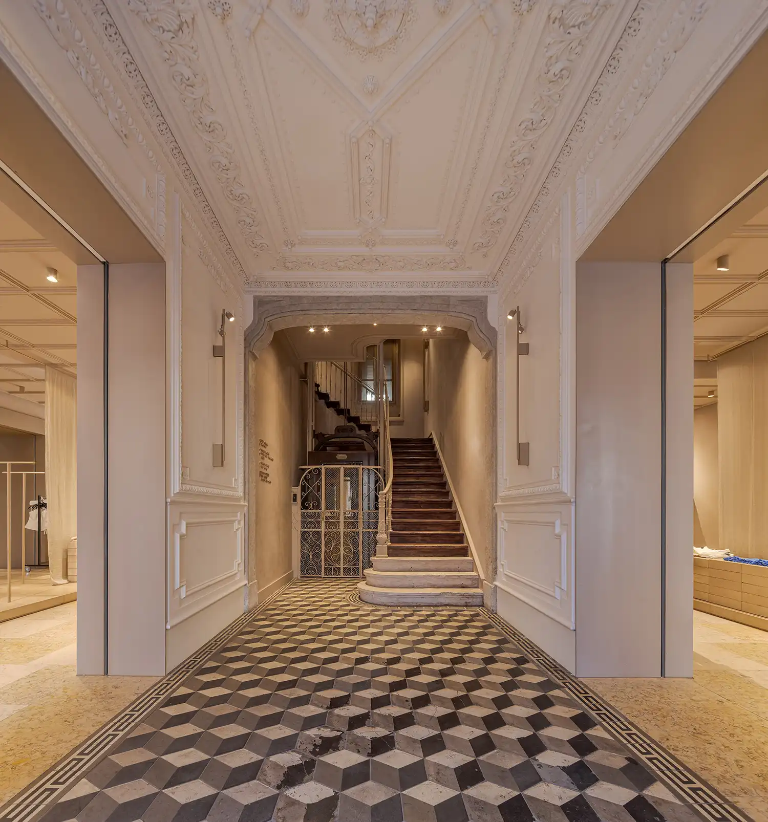 Restored entrance hall with decorative plaster ceilings and geometric tiled floors