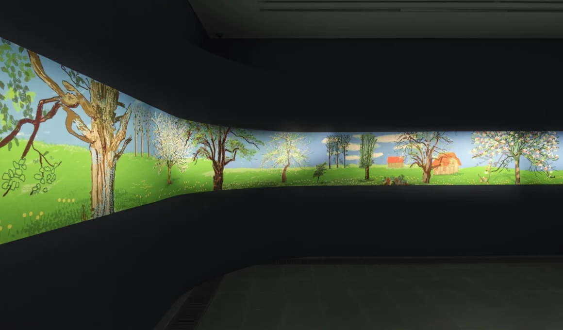 A wide-angle view of a curved dark gallery wall displaying David Hockney's illuminated digital landscape frieze.